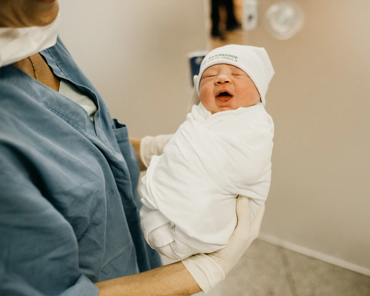 A newborn baby wrapped in a hospital blanket