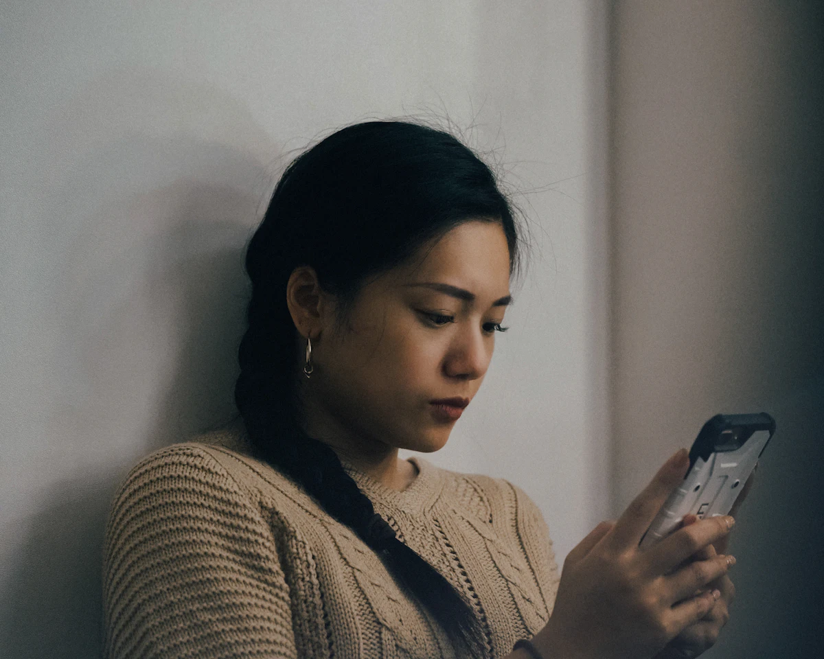 A woman using her smartphone at home